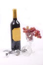 Bottle of red wine, and glass filled with grapes Royalty Free Stock Photo