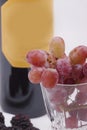 Bottle of red wine, and glass filled with grapes Royalty Free Stock Photo