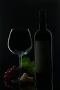 A bottle of red wine with a glass and grapes Royalty Free Stock Photo