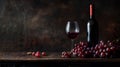 Bottle of red wine, glass of red wine, and grapes on a wooden table Royalty Free Stock Photo