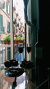 Bottle of red wine on glass table with two glasses of wine and fruit plate, balcony italian view