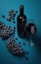 Bottle of red wine, grapes and blue glass on blue background. Royalty Free Stock Photo