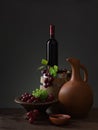 Bottle of red wine, grapes and wooden barrel Royalty Free Stock Photo