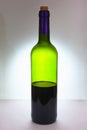 A bottle of red wine, half empty. Of green glass. Royalty Free Stock Photo