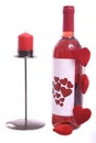 Bottle of red wine with red candle