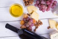 Bottle of red wine with snacks - various types of cheese, figs, nuts, honey, grapes on a wooden boards background Royalty Free Stock Photo