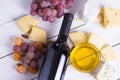 Bottle of red wine with snacks - various types of cheese, figs, nuts, honey, grapes on a wooden boards background Royalty Free Stock Photo