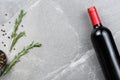 Bottle of red wine with spices on gray marble table Royalty Free Stock Photo