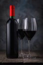 Bottle of red wine and two full glasses on a wooden table Royalty Free Stock Photo