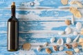 Bottle of red wine on vintage blue wooden board with seashells Royalty Free Stock Photo