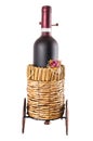 Bottle of red wine in wheeled basket Royalty Free Stock Photo