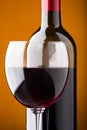 A bottle of red wine and a wine glass closeup Royalty Free Stock Photo