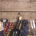 Bottle of Red Wine Wine Glass Ripe Grape on a Wooden Background Top view Flat Lay Copy Space Wine Background Wine Food Concept Royalty Free Stock Photo