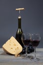 Bottle red wine and wine glasses, cheese and grape on wooden table Royalty Free Stock Photo