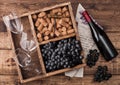 Bottle of red wine on wood with empty glasses with dark grapes with corks and opener inside vintage wooden box on grunge wooden Royalty Free Stock Photo
