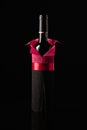 Bottle of red wine wrapped in crepe paper on a black background Royalty Free Stock Photo