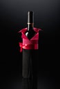 Bottle of red wine wrapped in crepe paper on a black background Royalty Free Stock Photo