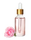 Bottle with rose essential oil and flower on background Royalty Free Stock Photo