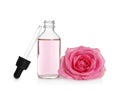 Bottle of rose essential oil, pipette and flower Royalty Free Stock Photo