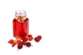 Bottle of rose hip oil on white background Royalty Free Stock Photo