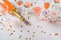 Bottle of rose sparkling wine on grey background with confetti Royalty Free Stock Photo