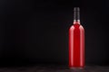 Bottle of rose wine mock up on elegant dark black wooden background, copy space. Royalty Free Stock Photo