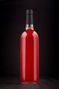 Bottle of rose wine mock up on elegant dark black wooden background, vertical. Royalty Free Stock Photo
