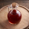 A bottle of rosehip seed oil on a wooden table Royalty Free Stock Photo