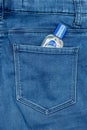 A bottle of sanitizing alcohol hand gel in the back pocket of a pair of jeans