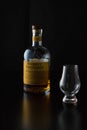 A bottle of scotch whisky and a glencairn glass