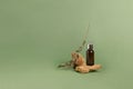 A bottle of serum oil cosmetic on an abstract podium made of natural materials stones plants green pastel background. Royalty Free Stock Photo