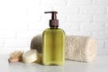 Bottle of shampoo, terry towel and wooden brush on white table Royalty Free Stock Photo