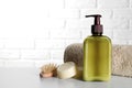 Bottle of shampoo, terry towel and wooden brush on white table, space for text Royalty Free Stock Photo