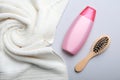 Bottle with shampoo, towel and brush on color background Royalty Free Stock Photo