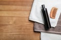 Bottle of shampoo, towels and comb on wooden background, top view Royalty Free Stock Photo