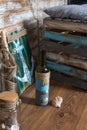 Bottle with shells, anchor painting, sea theme on wooden background