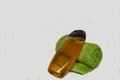 Bottle of shower gel and a terry green towel on a white background Royalty Free Stock Photo