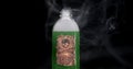 Bottle with skull and crossbones warning label, filled with toxic green liquid bubbling up and smoking. Concept for suicide by