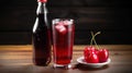 a bottle of soda and a glass of cherry soda on a table