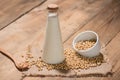 A bottle of soy milk or soya milk and soy beans on wooden table. Royalty Free Stock Photo