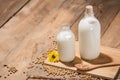 A bottle of soy milk or soya milk and soy beans on wooden table. Royalty Free Stock Photo