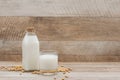 Bottle of soy milk and soybean on wooden table Royalty Free Stock Photo