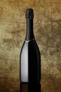 Bottle of sparkling wine on colorful gold background Royalty Free Stock Photo