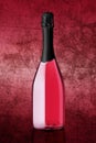 Bottle of sparkling wine on colorful pink background Royalty Free Stock Photo