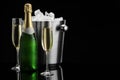 Bottle of sparkling wine, glasses and cooler bucket on black mirror surface. Space for text Royalty Free Stock Photo
