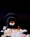 A bottle of spilled pills on black background. Levitating tablets. Tablets on a dark background that are falling. Tablets. Medicin Royalty Free Stock Photo