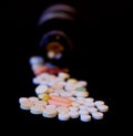 A bottle of spilled pills on black background.Levitating tablets. Tablets on a dark background that are falling. Tablets. Medicine Royalty Free Stock Photo