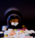 A bottle of spilled pills on black background.Levitating tablets. Tablets on a dark background that are falling. Tablets. Medicine