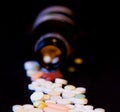 A bottle of spilled pills on black background.Levitating tablets. Tablets on a dark background that are falling. Tablets. Medicine Royalty Free Stock Photo