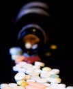 A bottle of spilled pills on black background.Levitating tablets. Tablets on a dark background that are falling. Tablets. Medicine